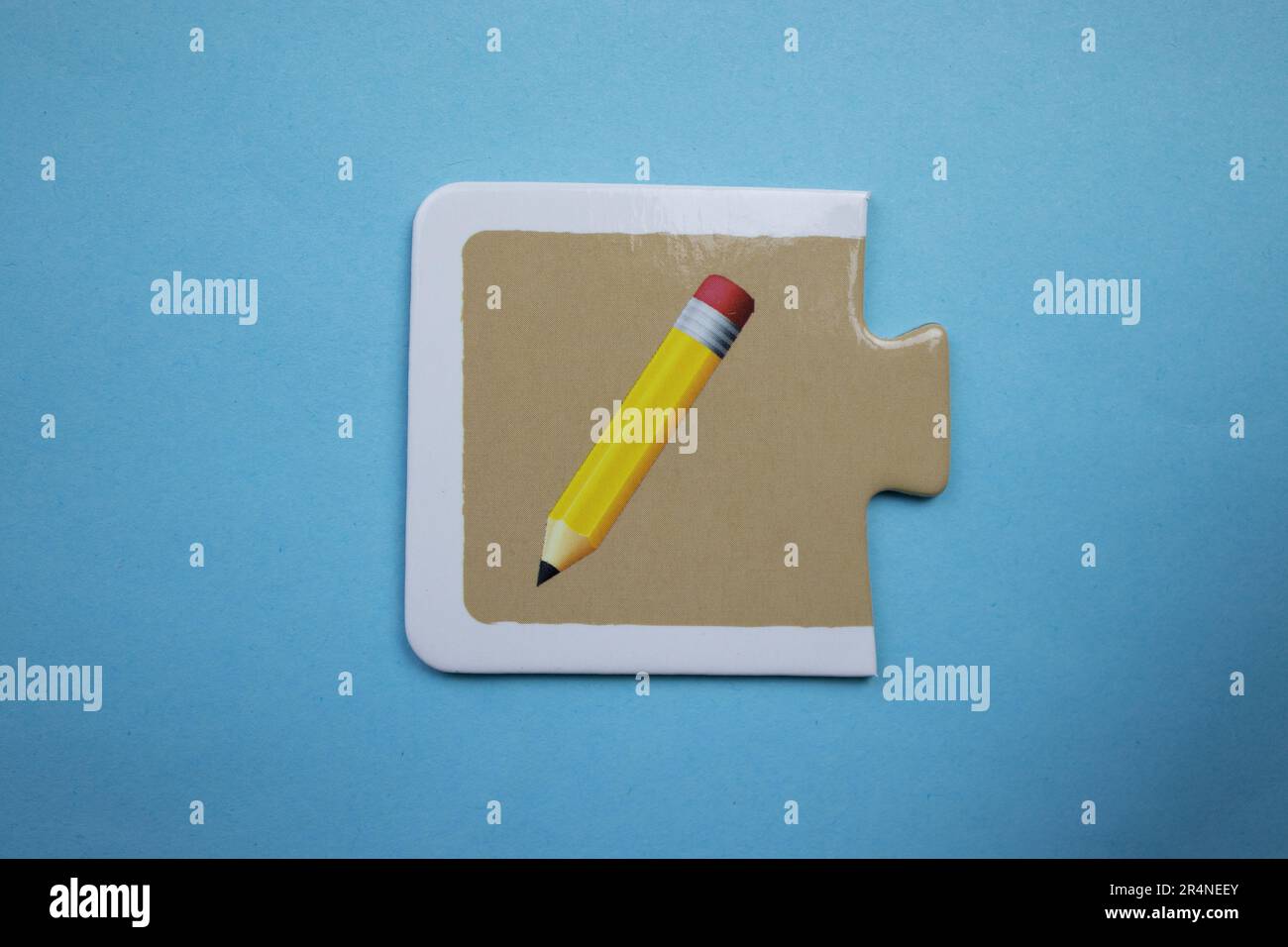 Picture puzzles placed on a blue background. Pencil Stock Photo