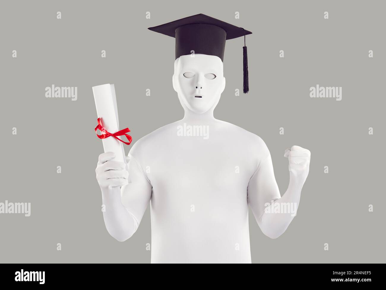 University student in white bodysuit, mask and academic cap celebrating graduation Stock Photo