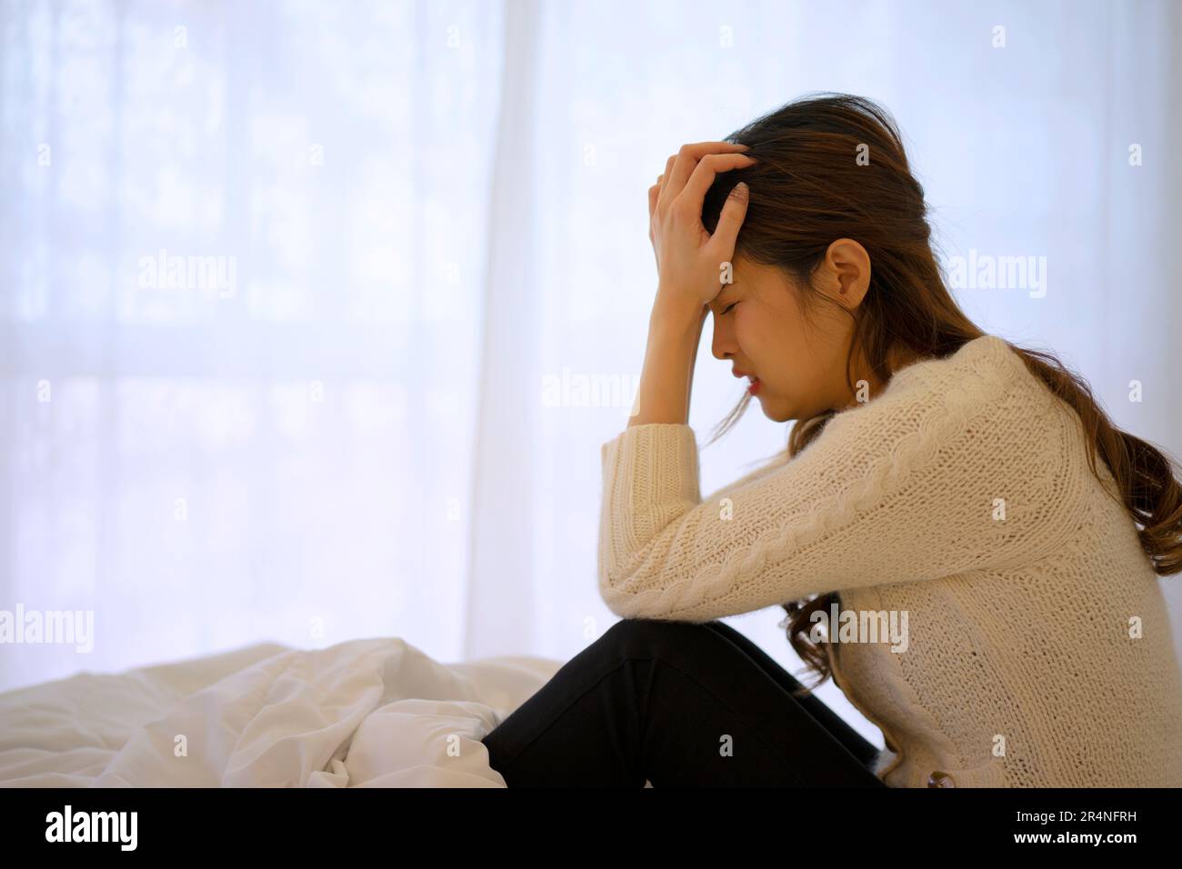 Pretty woman has emotional stress at bedroom. Emotional stress and mental health concept. Stock Photo