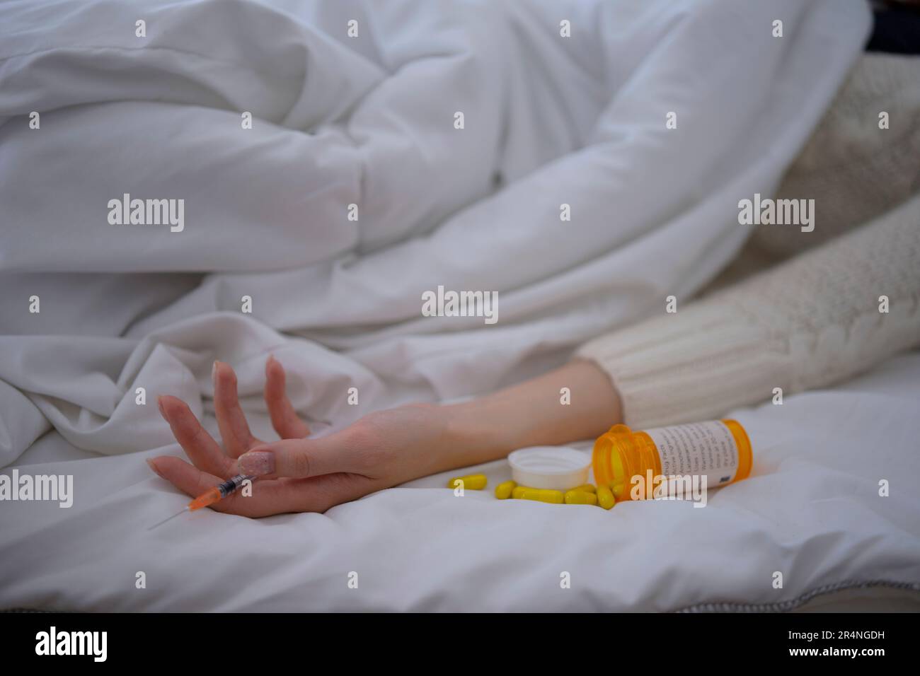 Woman suicide herself by overdose medicine. Emotional stress and mental health concept. Stock Photo