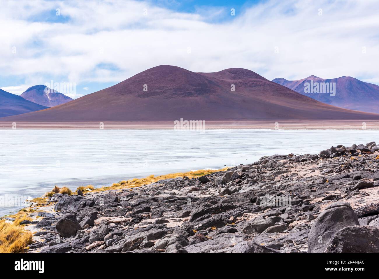 Andes mountain range viewed from frozen lake in the bolivian plateau Stock Photo