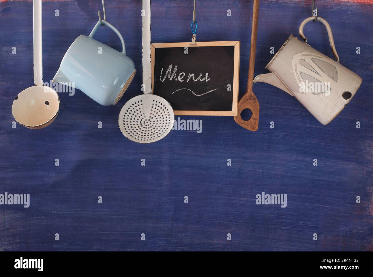 Restaurant menu with vintage kitchen utensils and message on blackboard