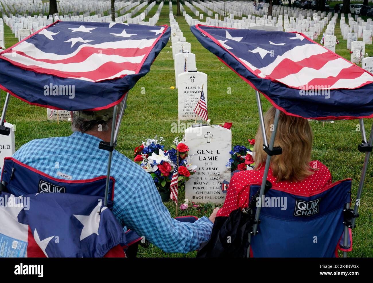 Eugene and Linda Lamie, of Homerville, Ga., sit by the grave of their