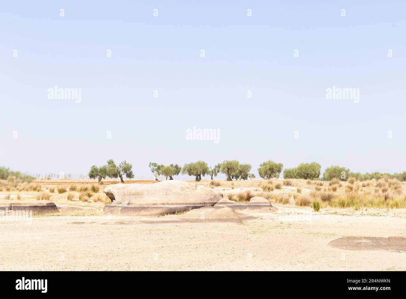 View of desert landscape due to lack of water. On rocks you can see mark of water level. Stock Photo