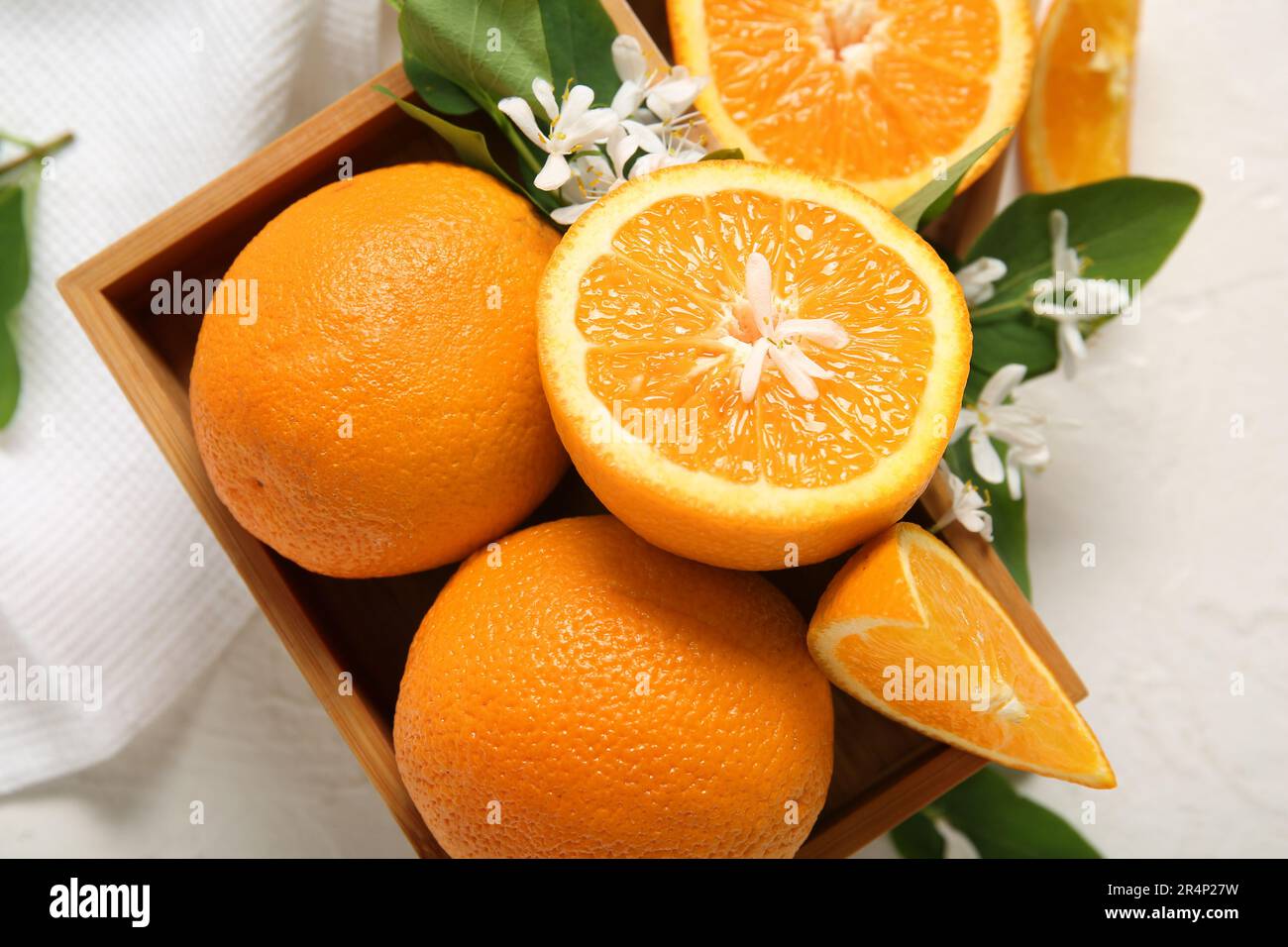 Wooden box of oranges with blooming branch as background Stock Photo ...