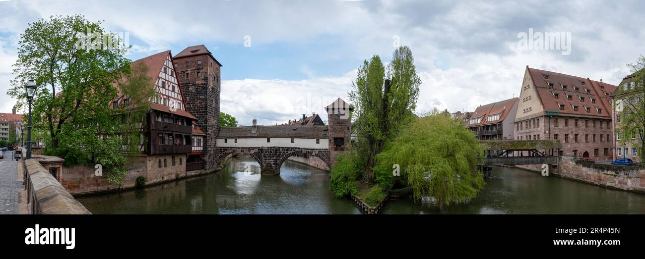 Panoramic view of old covered medieval bridge over Pegnitz river in Nuremberg, Germany. Hangman's Bridge. Stock Photo