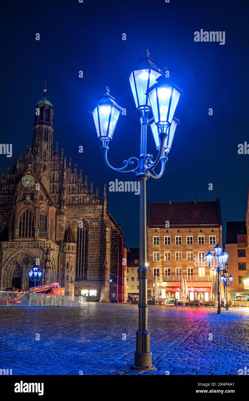 Blue street lights in front of the Frauenkirche in Nuremberg. The blue