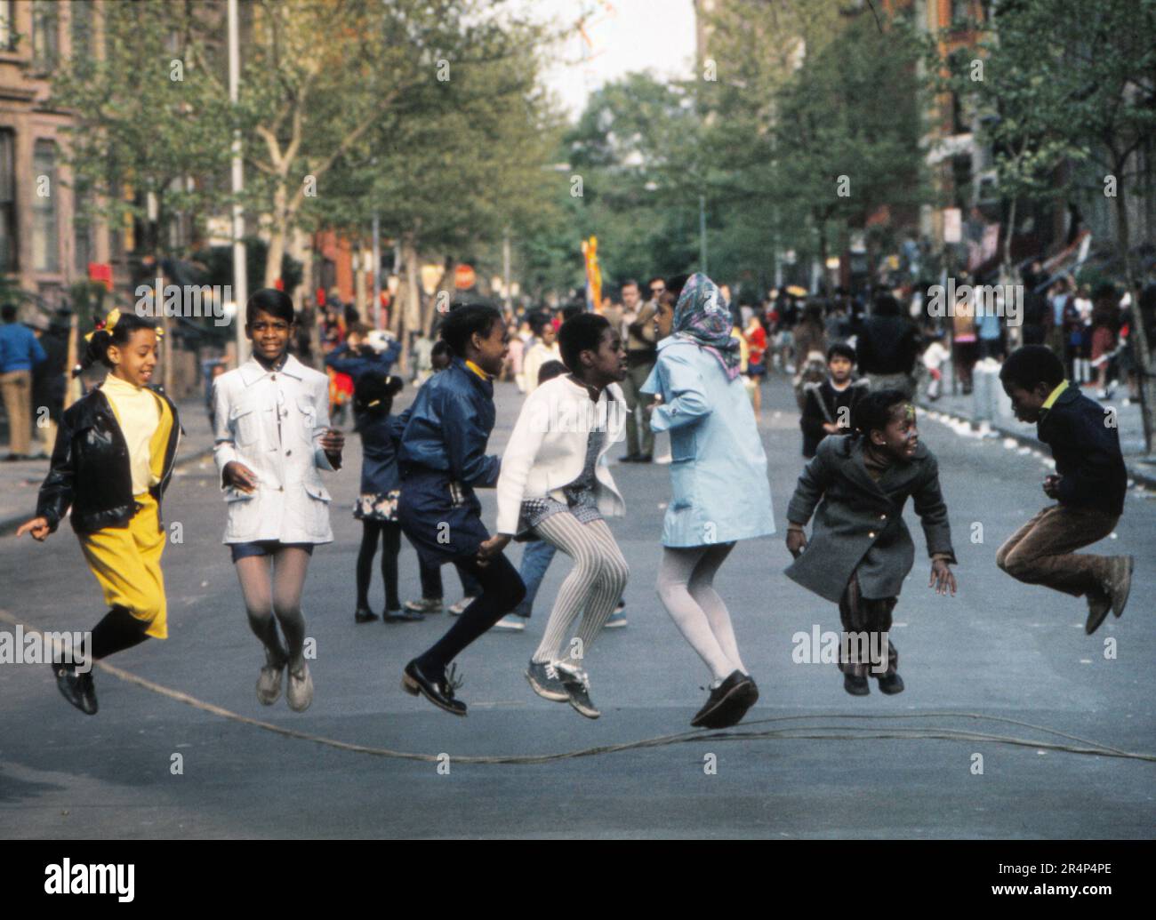 Block party in Brooklyn NY with a group of children jumping rope and ...