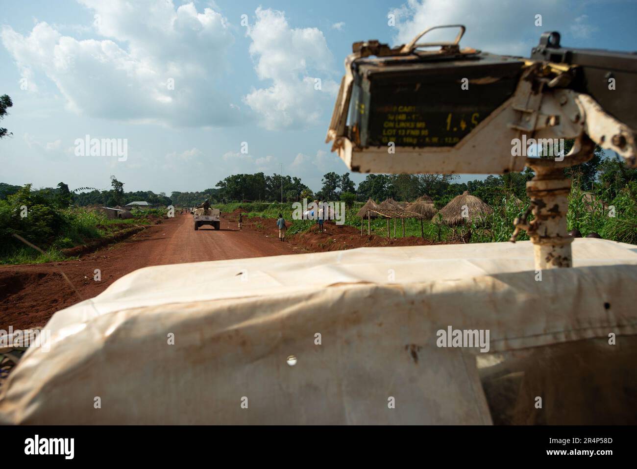 A United Nations peacekeeping convoy operates on a dirt road in DRC, near Dura.  The 0.50 calibre M2 Browning machine gun is armed with live rounds, and operated by military personnel from the Moroccan army Stock Photo