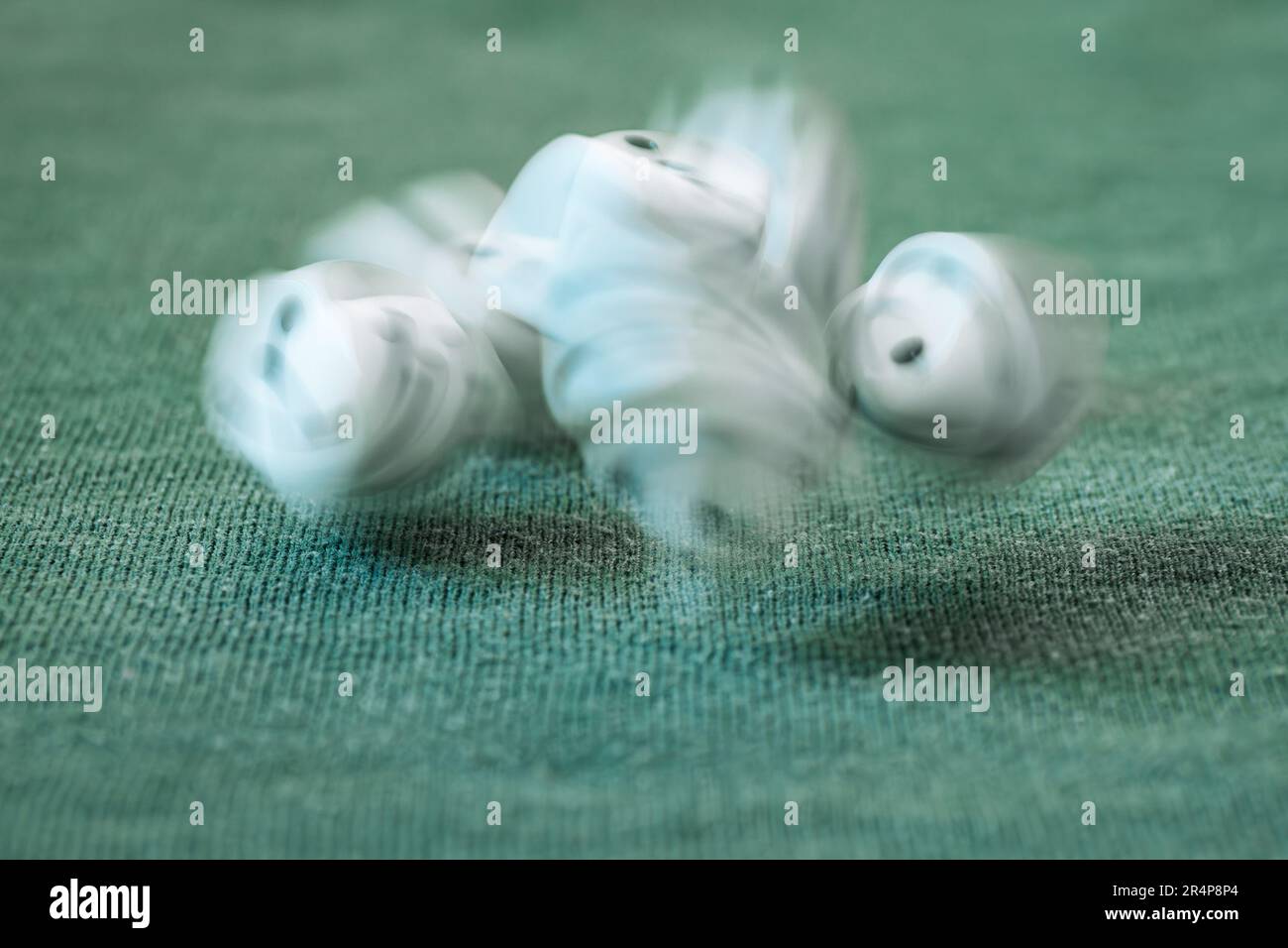 some white game dices in movement falling on green background as success, chance, choice, decision, luck, lifestyle, balance, fear, greed concept Stock Photo