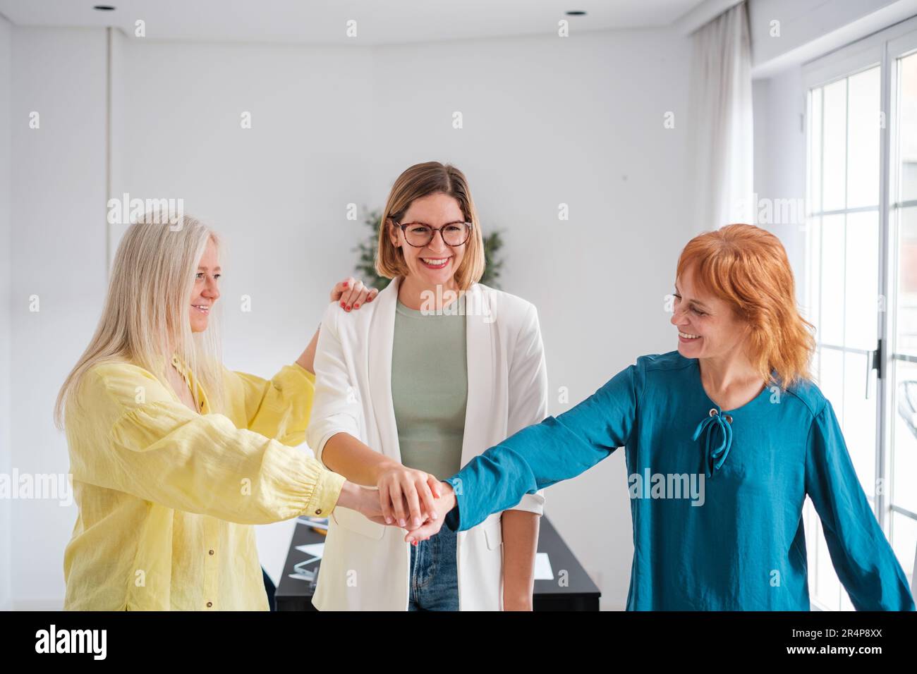 Group of women joining hands and forces to generate a powerful company. Concept: business, start up, empowered women Stock Photo