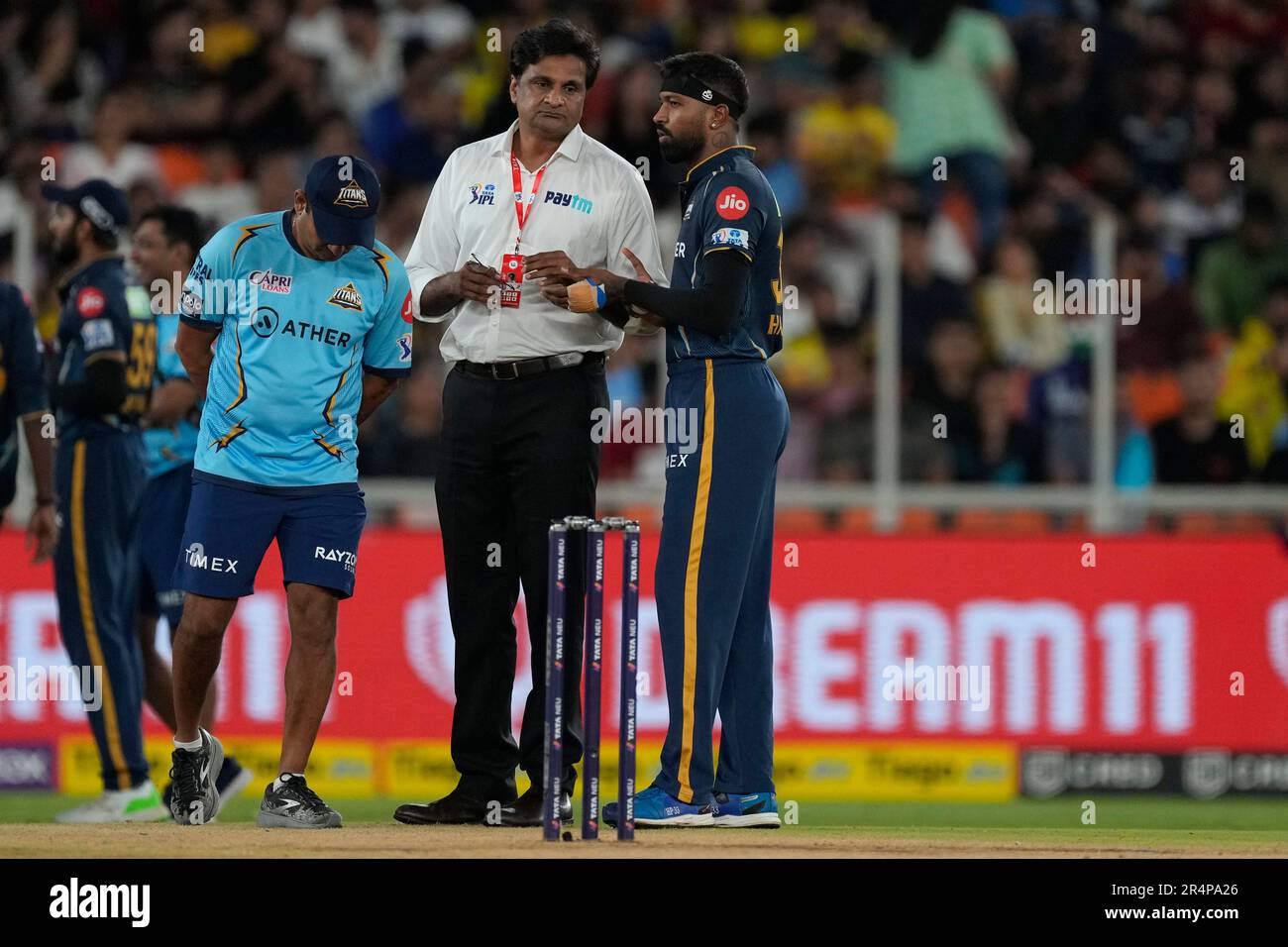 Gujarat Titans' captain Hardik Pandya, right, interacts with match