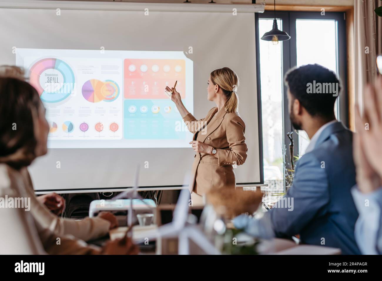 Female business leader giving a presentation about renewable energy ...