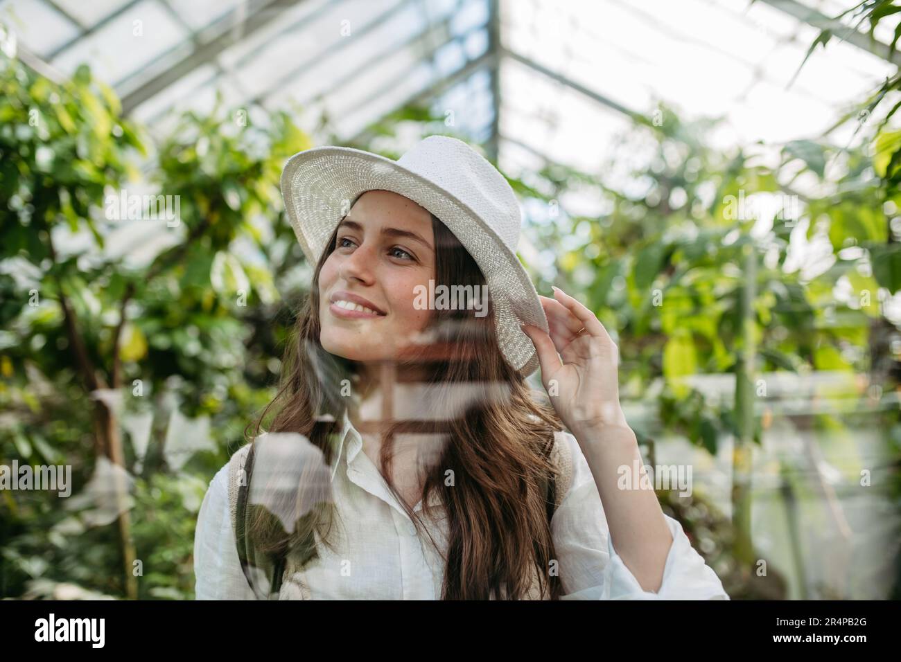 Portrait of young woman in botanical garden. Stock Photo