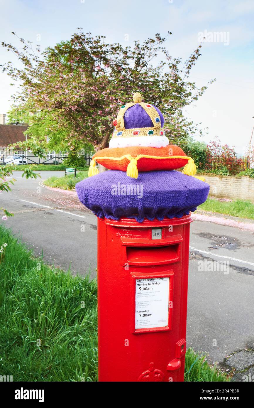A knitted postbox cover celebrating the coronation of King Charles III