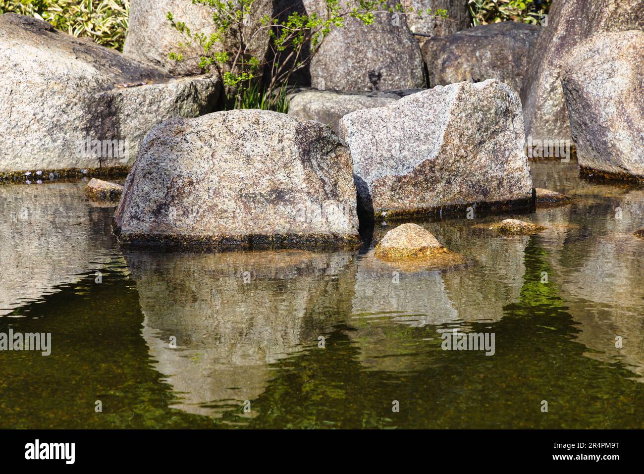 picture of large rocks at a pond of a landscaped Japanese garden Stock ...