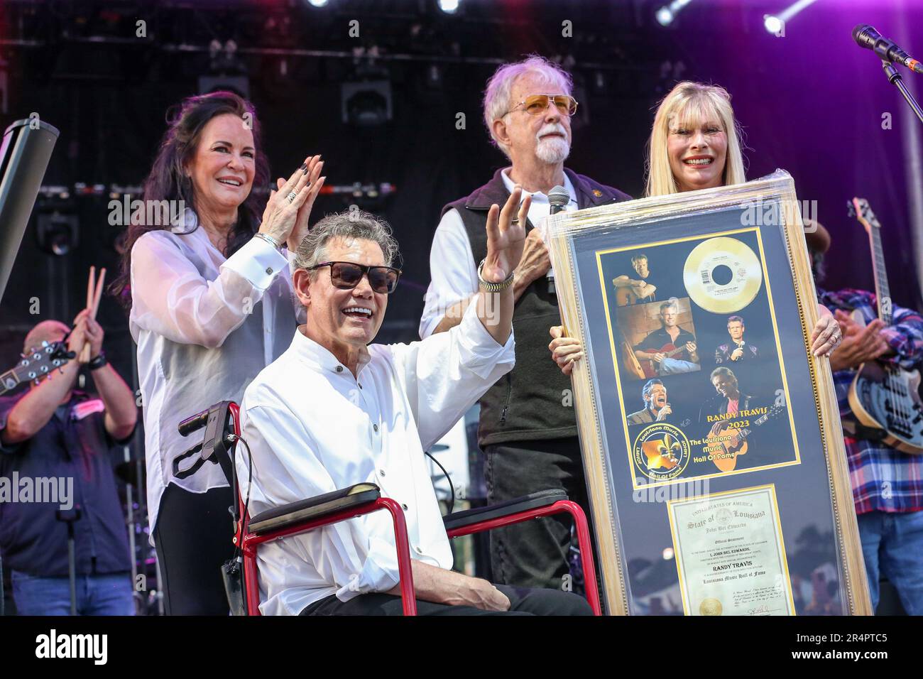 Denham Springs, LA, USA. 27th May, 2023. Country music superstar Randy Travis waves to the crowd as his wife Mary Davis looks on as he is inducted into The Louisiana Music Hall of Fame during Day 1 of the 2023 Cajun Country Jam Memorial Day Festival at PADS North Park in Denham Springs, LA. Jonathan Mailhes/CSM(Credit Image: © Jonathan Mailhes/Cal Sport Media). Credit: csm/Alamy Live News Stock Photo