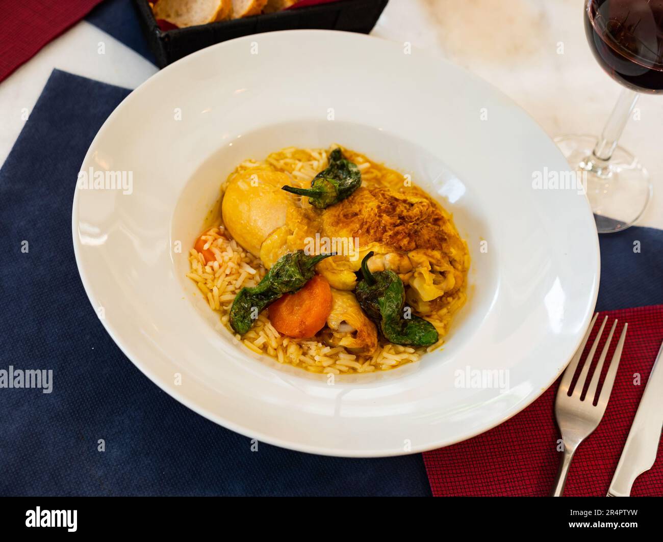 Dish of chicken thigh curry with rice and padron pepper Stock Photo Alamy