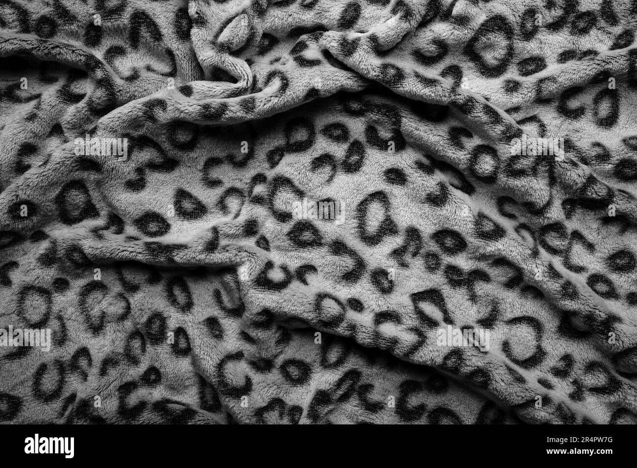 Soft fleecy faux fabric with a mottled pattern. Light leopard texture. Stock Photo