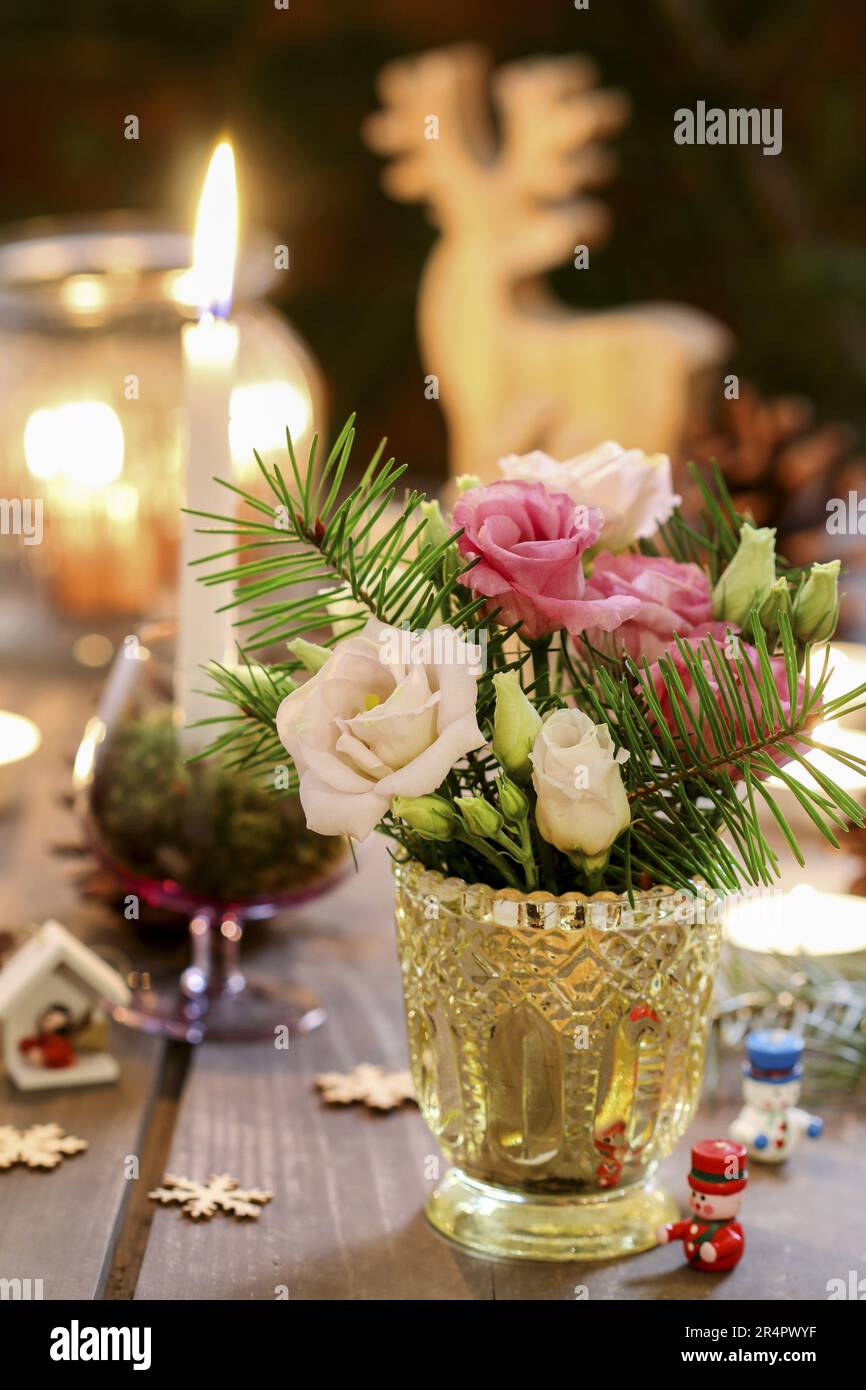 Small table decoration with eustoma flowers and fir. Party decor Stock