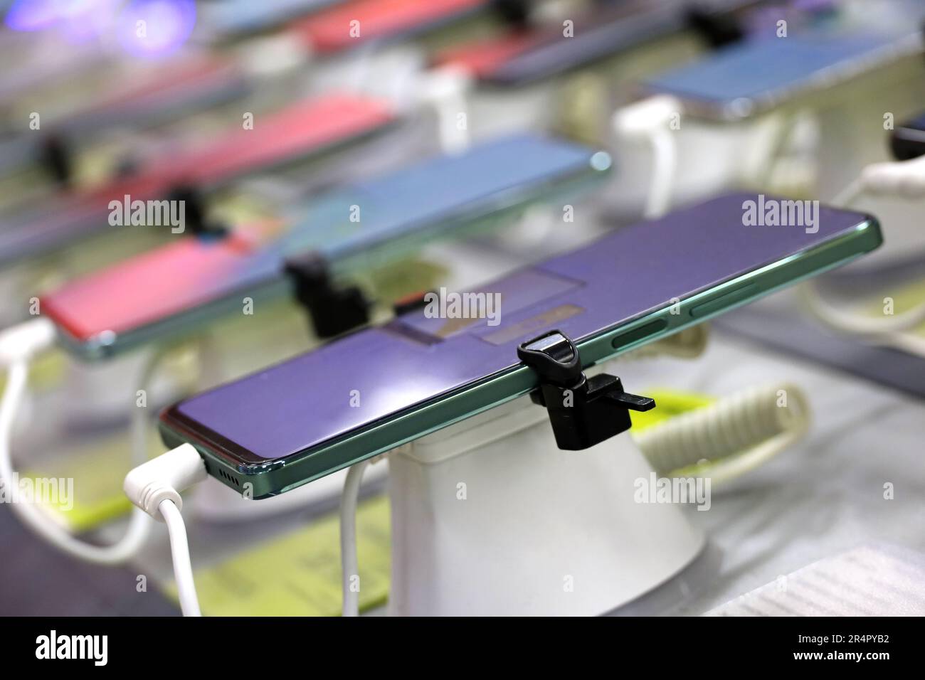 New smartphones in a shop. Mobile phones in a row in electronics store Stock Photo
