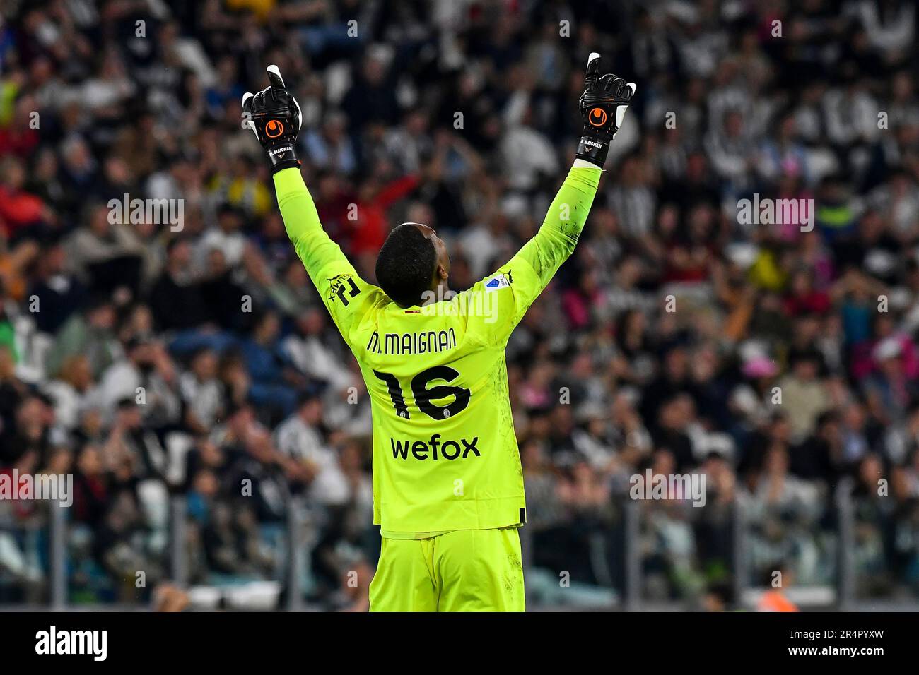 Mike Maignan of AC Milan celebrates after Olivier Giroud (not pictured) scored the goal of 0-1 during the Serie A football match between Juventus FC a Stock Photo