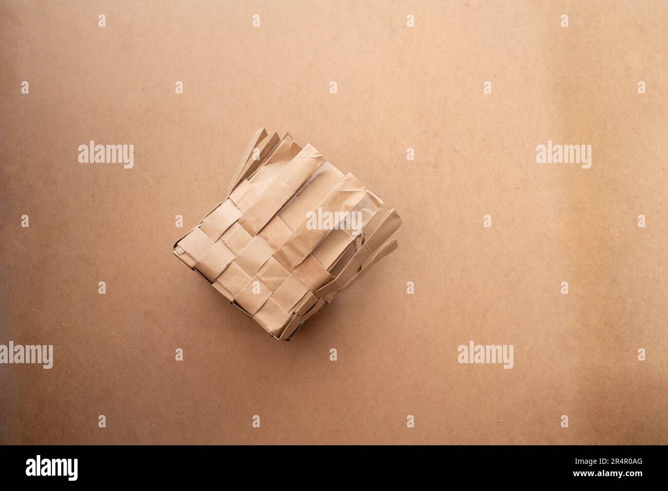 paper basket making process, braided paper stripes, side view Stock