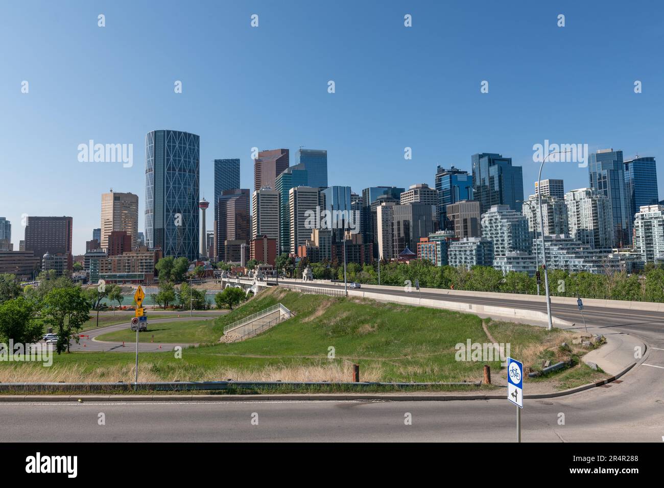 Pano views along Centre St Bridge in Calgary, Alberta on a blue sky day with city skyline in view, tower, sky scrapers in scenic skyscape landscape. Stock Photo