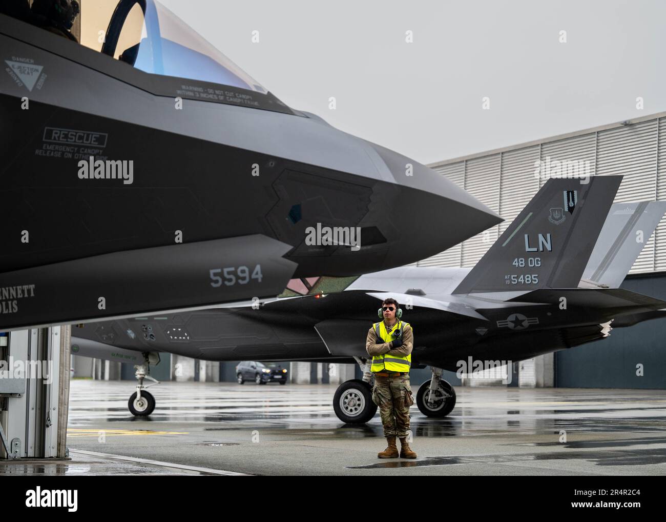 U.S. Air Force Airman Robbie Lettieri, assistant dedicated crew chief assigned to the 493rd Fighter Squadron, marshalls an F-35A Lightning II onto the taxiway for the kick-off of Arctic Challenge Exercise 2023 at Ørland Air Base, Norway, May 29, 2023. The advanced fifth-generation fighter will integrate and operate alongside 13 nations and NATO throughout the exercise, which provides critical training in a highly complex and harsh Arctic environment. RAF Lakenheath’s ability to forward deploy and operate in routine exercises with the F-35 highlights U.S. European Command’s focus on maintaining Stock Photo