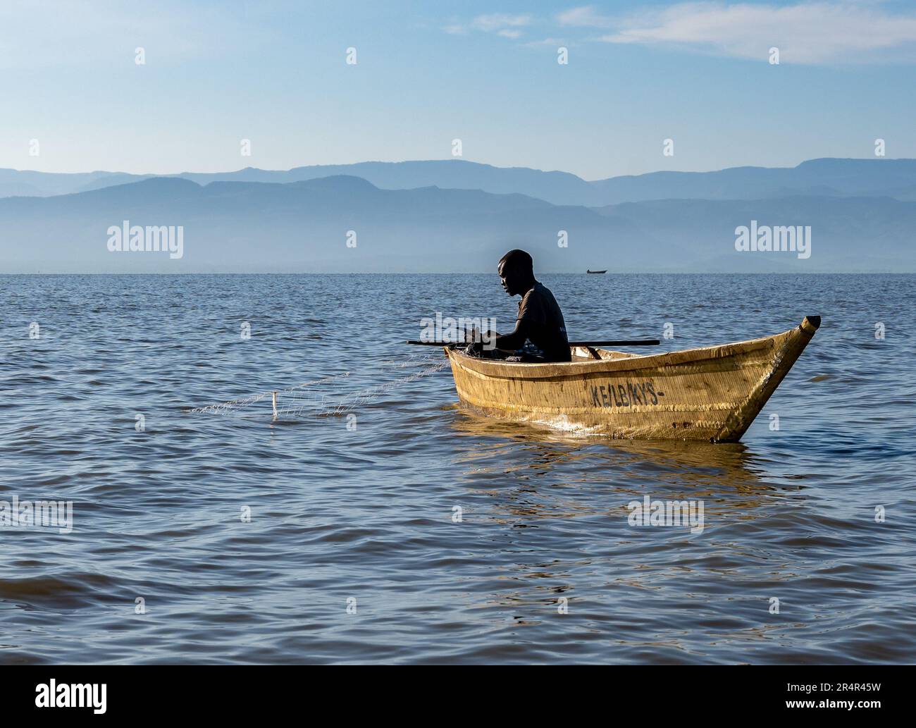 A man fishing in a small boat on the Lake Baringo. Kenya, Africa. Stock Photo