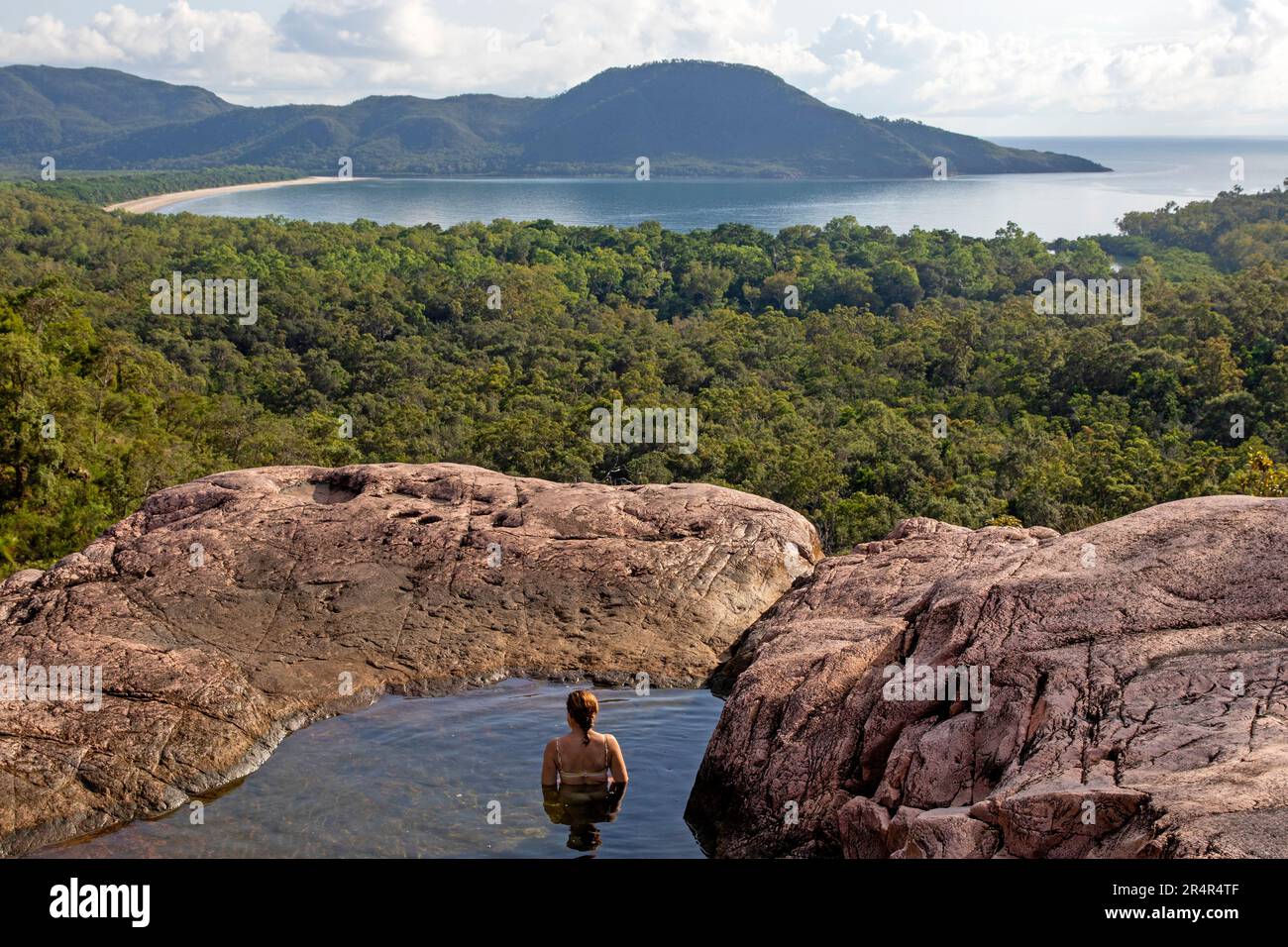 Woman swimming in a pool at the top of Zoe Falls, Hinchinbrook Island