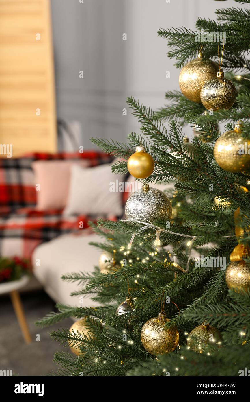 Christmas tree with golden and silver balls in living room Stock Photo ...
