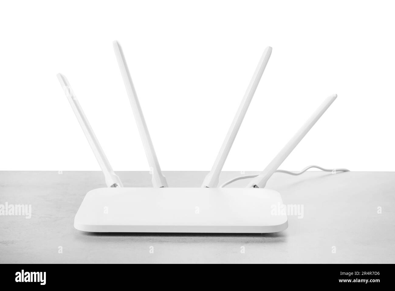 New modern WiFi router on grey table against white background Stock