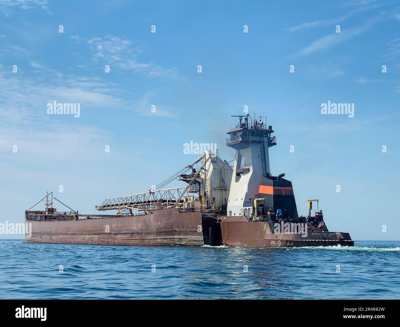 The Dorothy Ann tug pushing the Pathfinder barge on Lake Michigan Stock