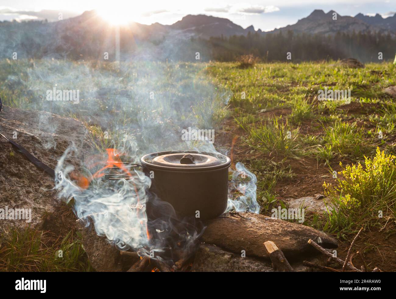 Touristic kettle on fire of burning campfire in camping in the hike ...