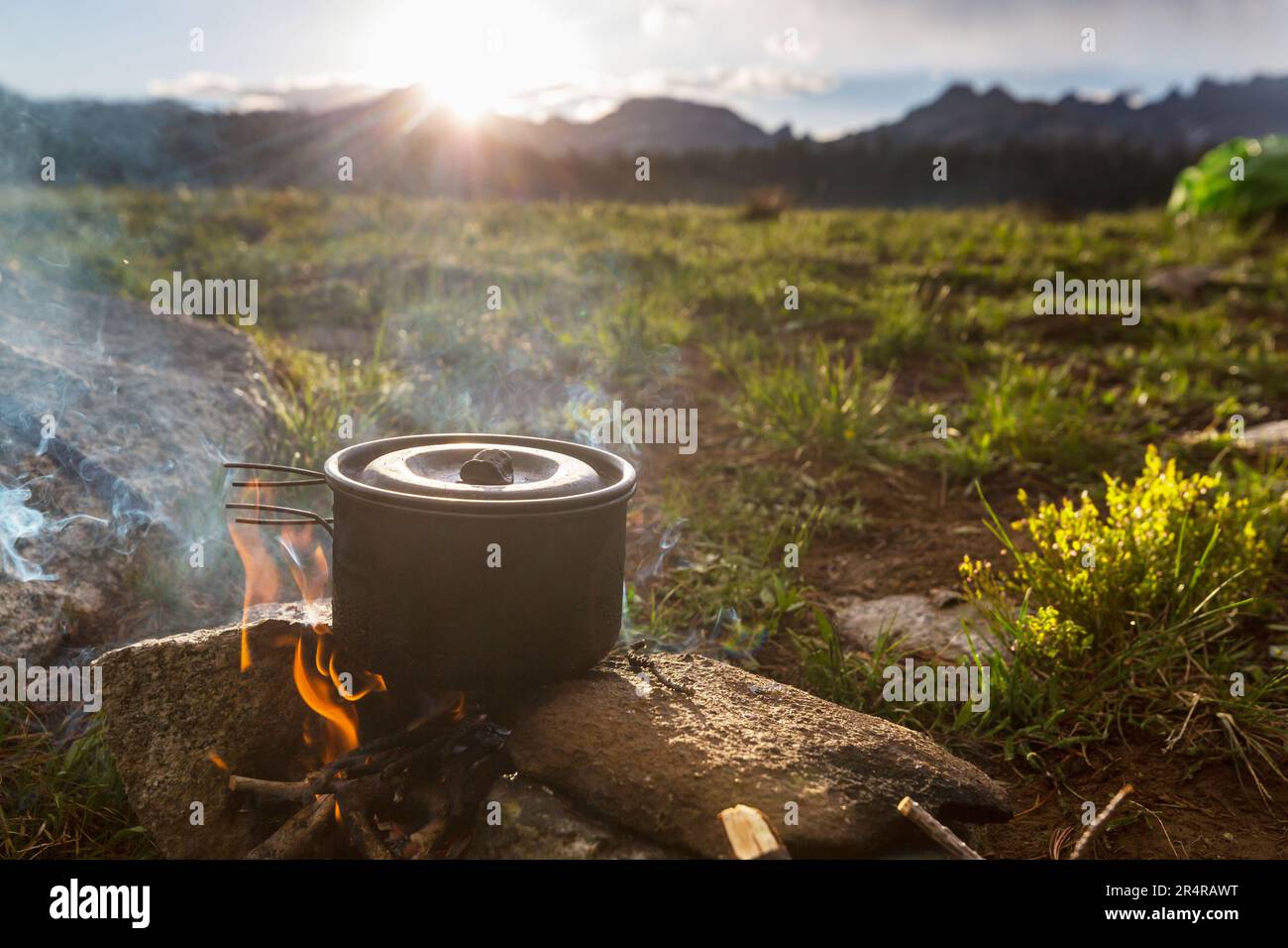 Touristic kettle on fire of burning campfire in camping in the hike ...