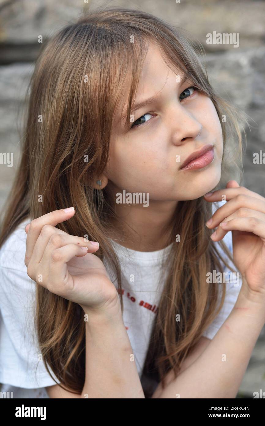 Innocent Teenage Girl with Beautiful Blonde Hairstyle Portrayed in Headshot Portrait Stock Photo