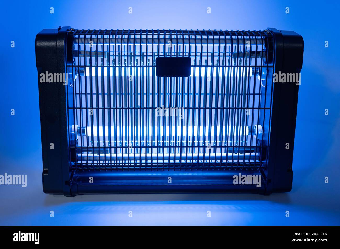 Uv lamp trap for insects with blue light on studio background Stock Photo Alamy