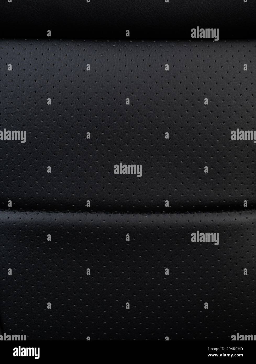 Clean black perforated leather textur plane macro close  up view Stock Photo