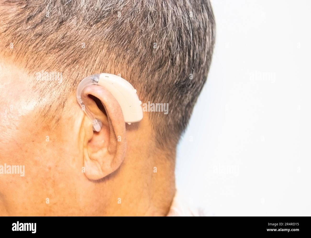 An old man wears a hearing aid, closeup Stock Photo Alamy