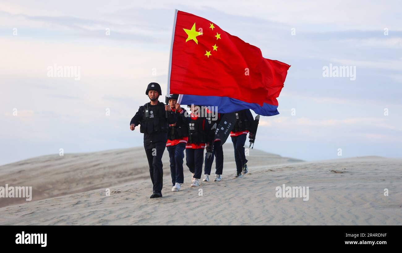 ALTAY, CHINA - MAY 29, 2023 - Police officers and students patrol the border to celebrate the International Children's Day in Altay, Xinjiang Province Stock Photo