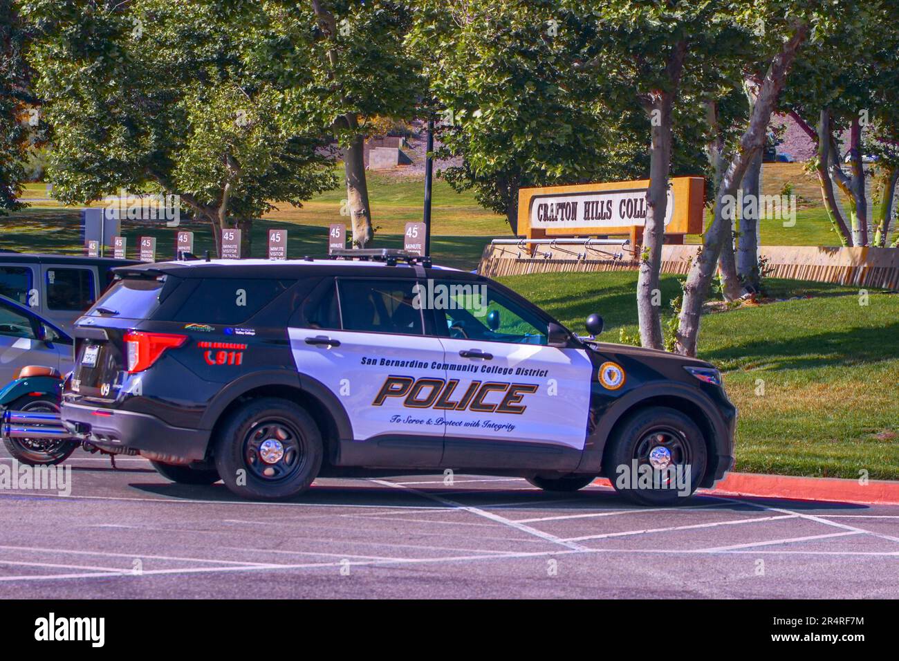 A photograph showcasing a San Bernardino Community College Police Vehicle, with the Crafton Hills College sign prominently displayed in the background Stock Photo