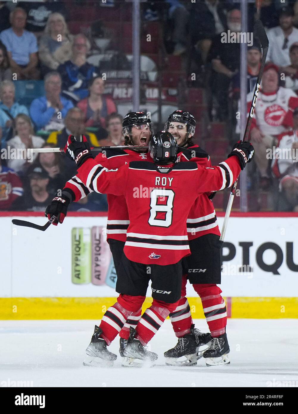 Quebec Remparts Charle Truchon, back left, celebrates his empty-net goal he scored from near his own net with Nicolas Savoie, back right, and Pier-Olivier Roy during third-period CHL Memorial Cup hockey game