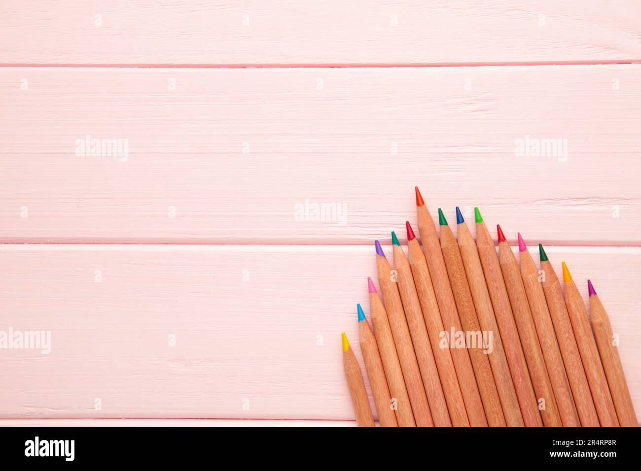 Colored pencils on the pink background. Top view Stock Photo - Alamy