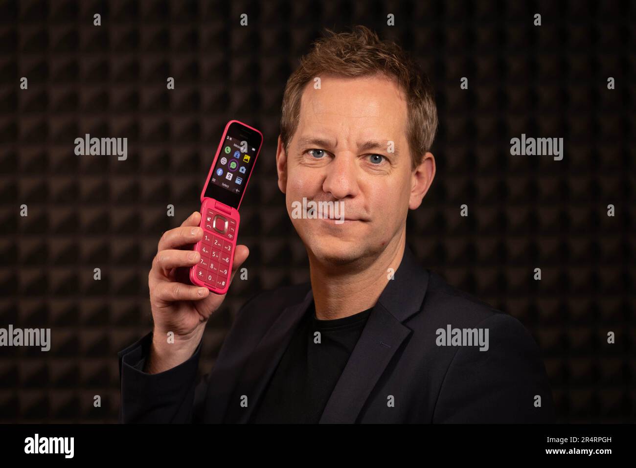EDITORIAL USE ONLY Lars Silberbauer, Chief Marketing Officer from HMD Global, the maker of Nokia phones, unveils two all-new 2660 Flip phones in Pop Pink and Lush Green. Issue date: Tuesday May 30, 2023. Stock Photo