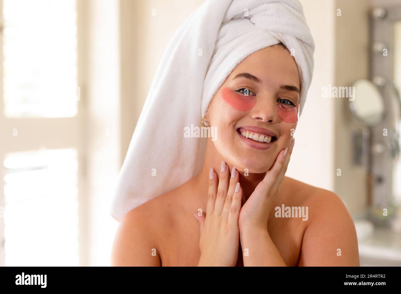 Portrait of plus size caucasian woman with towel wrapped on head and red eye patches under eyes Stock Photo