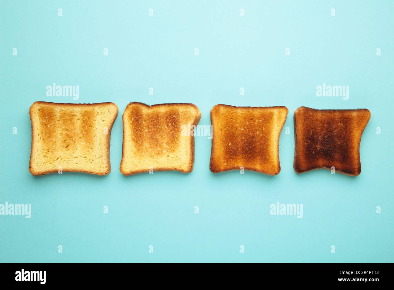Slices Of Toast Bread On Light Blue Wooden Table, Top View Stock