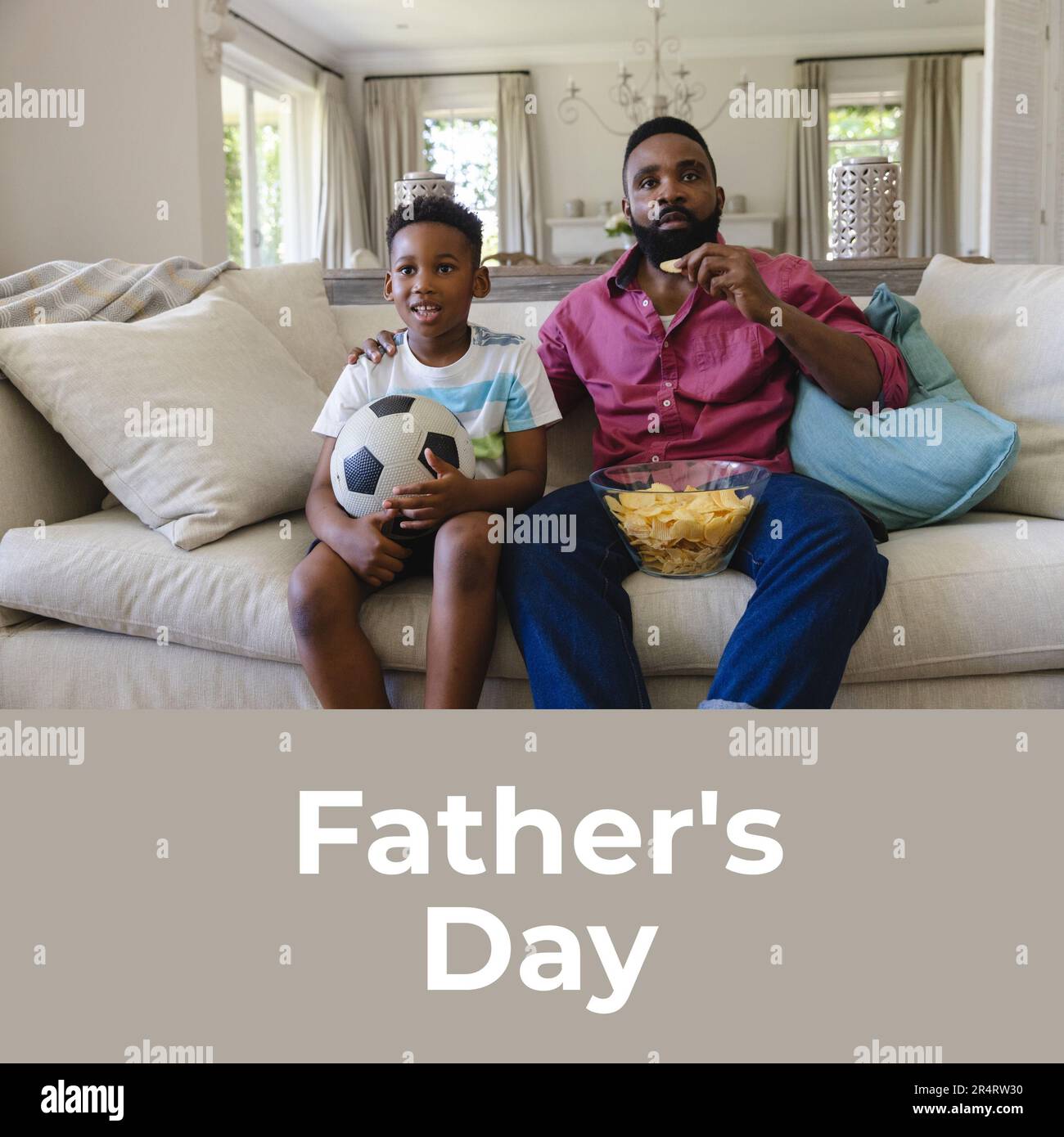 Composition of father's day text over african american man with son watching football Stock Photo