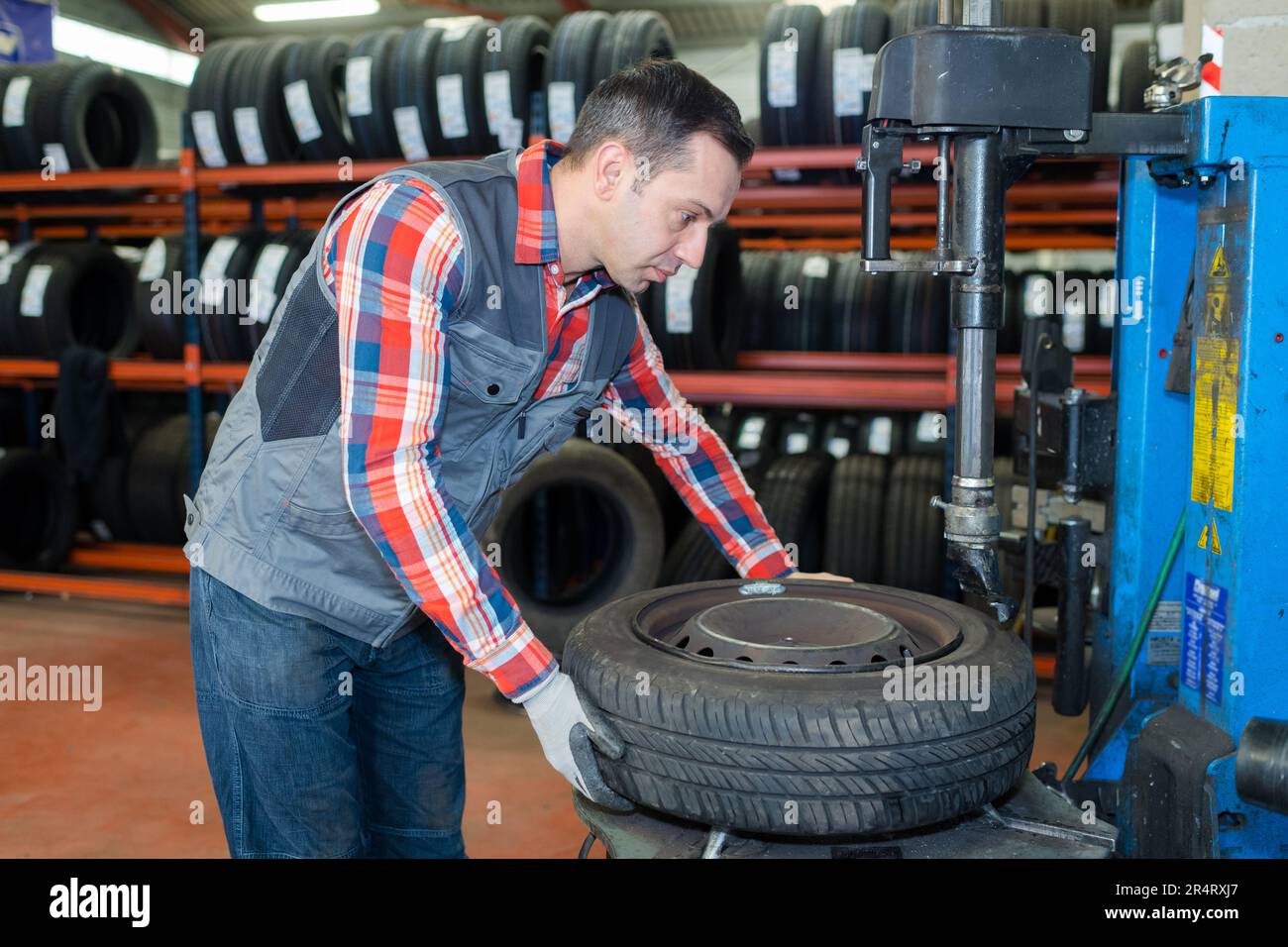 vulcanizing shop worker removing the tire from the rim Stock Photo Alamy