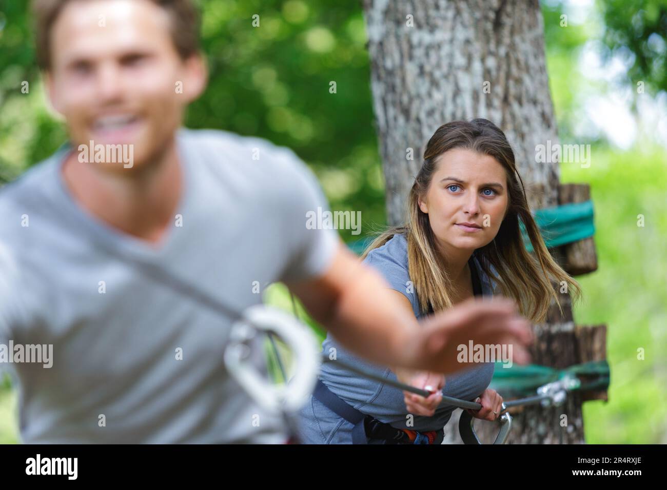 man walking along rope bridge Stock Photo - Alamy